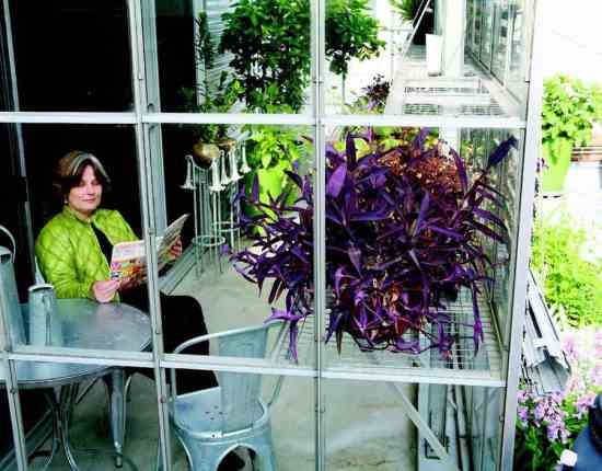 The solar-powered greenhouse adjacent to the roof garden provides a warm, sunny spot for reading on a cool day.